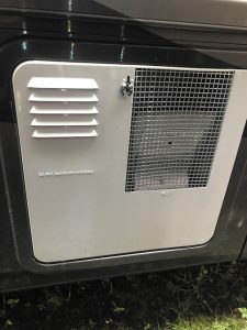 For owner maintenance tasks, such as cleaning and draining the unit, remove the exterior cover of the RV water heater to expose the components.