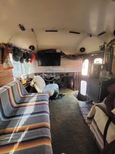 For nearly 50 years, Ron Amos has lived in his converted school bus, adding a wood-burning stove, back porch, second-story bedroom, new engine, and more to the “skoolie.”