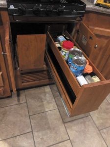 In this RV, the dishwasher was replaced with pull-out spice/pantry racks, creating additional storage.