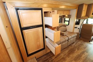The main slideout holds the refrigerator, pantry, and theater seating.