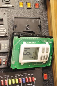 The original thermostat was disassembled for access to the mounting screws on the backplate.