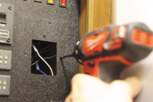 The author drilled mounting holes for the new thermostat.