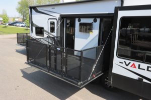 The 42V13 features a side patio with safety rails, plus outdoor steps and doors to the garage and living area.