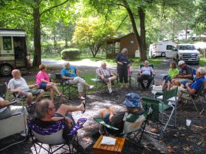 At right, Gaye Young (standing), national vice president, Eastern Area, and her husband, Jerry, paid a visit to the GMC Colonial Travelers at their 40th anniversary rally.