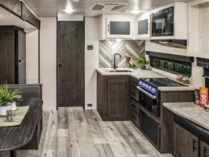The L-shaped galley includes a cooktop, microwave, and regular oven.