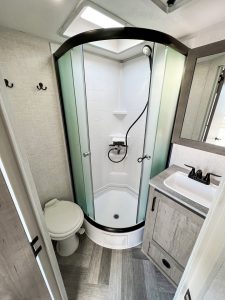 The rear bathroom includes a 32-inch-radius shower with a Showermiser to conserve fresh water when dry camping.