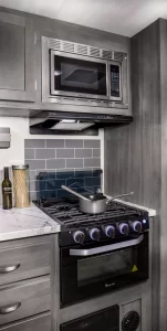 The galley includes a three-burner stove, plus conventional and microwave ovens.