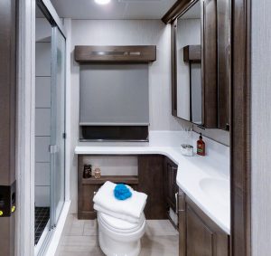 The Charleston’s bath features a fully tiled shower with sliding glass doors; a porcelain toilet; a vanity and solid-surface countertop; and several storage possibilities.