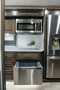 The Charleston’s galley includes an electric induction glass cooktop, stainless-steel dishwasher, microwave-convection oven, and residential refrigerator.