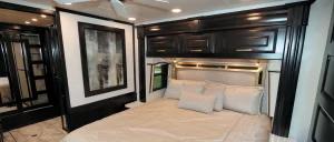 The bedroom, with a king-size bed, is positioned next to the rear bath.