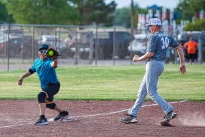 A member of the Amarillo Senior Softball Club catches the ball during a game.
