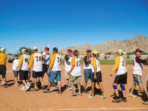 After the game at Fortuna de Oro RV Resort, the teams exchange friendly high-fives.