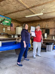 Gaye Young, then-national vice president, Eastern Area, presented a certificate and check from FMCA to chapter president Glenn Himes.