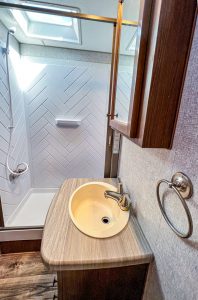 The rear bathroom contains a residential-sized shower and a skylight.