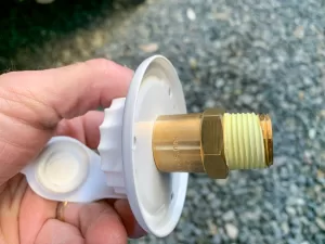 Apply PTFE tape or liquid sealant to the male threads on the new fitting. 