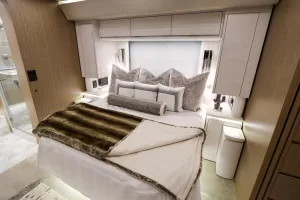 In the P50 toured for this article, the bedroom makes an elegant refuge with designer fabrics, cabinetry, and lighting.