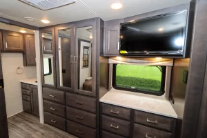 The 38MX’s bedroom offers plentiful drawer and wardrobe storage across from the bed, with an LED TV above the window.
