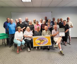 During their September rally, Rocky Mountain members gathered for a photo and displayed the 55th anniversary certificate the chapter received from FMCA.