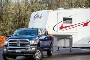 When backing or making a sharp turn, the fifth-wheel hitch must be in a position to keep the front of the trailer from impacting the rear cab of the pickup.