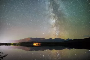 The Milky Way reflects on Pyramid Lake at Jasper National Park in Alberta.