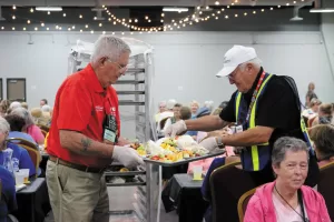 Herman Mullins filled many volunteer roles at FMCA events, such as pitching in to serve at the Ladies’ Luncheon during the Lincoln, Nebraska, convention in August 2022.