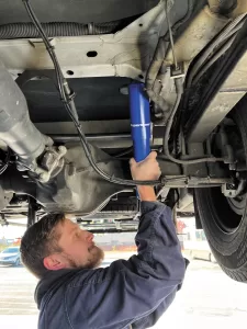 Tommy Henderson installs custom-tuned SuperSteer SS88-1889 rear shocks on a Winnebago Navion motorhome at Henderson’s Line-Up.