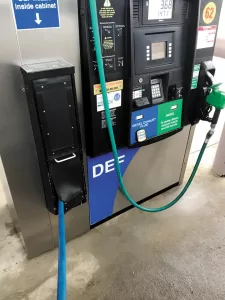 Some fuel stations offer pump DEF, with the nozzle stored behind a rubber flap.