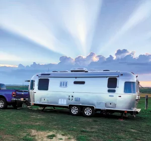 In South Dakota, sunrise silhouetted an Airstream at Porter Sculpture Park, a Harvest Host facility near Montrose, in this photo by Judy Bowen.