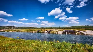 Firehole River flows through geyser basins and over three major waterfalls: Kepler Cascades, Firehole Falls, and the Cascades of the Firehole.