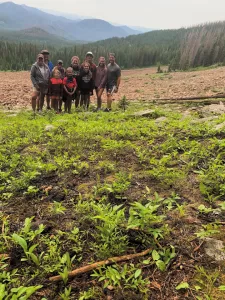 The entire crew posed for a photo with a gorgeous mountain backdrop