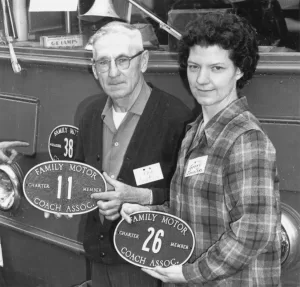 Genny and Dennis McGuire, an FMCA founder, display their original member plates.
