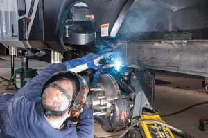 Installation includes welding the risers onto both sides of the trailer frame, adding a 3-by-3-inch steel tube crossmember between them, and welding the MORryde IS axles to the risers. 