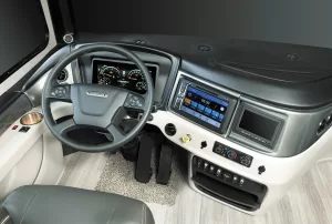 The driver’s area includes Freightliner's DriveTech steering wheel and OptiView information center. 