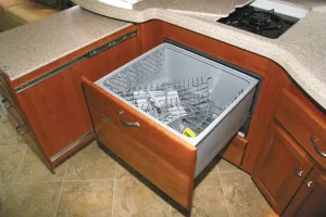 If your RV has a drawer-type dishwasher, run a brief cycle until antifreeze appears in the drum. Then switch to the spin cycle to drain it and pass it through the drain lines and trap.