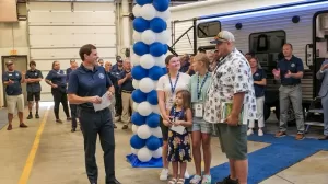 Blue Compass RV CEO Jon Ferrando surprised a family by gifting them the Jayco RV they had ordered.