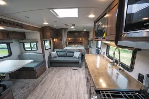 The standard layout includes a convertible dinette in the slideout and a jackknife sofa against a half wall.
