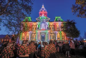 The Dickens Victorian Village Courthouse light show is a nighttime visual spectacular.