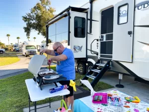 Scott prepares a tasty meal outdoors.