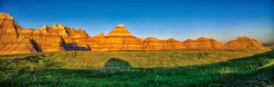 Driving through the South Dakota Badlands as sunset approached, Ron Everdij photographed the striated mountains and the shadow of his Mini Cooper towed car.
