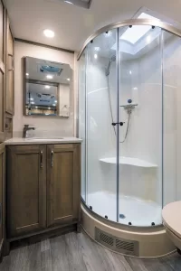 The rear bath has a large shower that conserves water with an Aqua View Showermiser system.