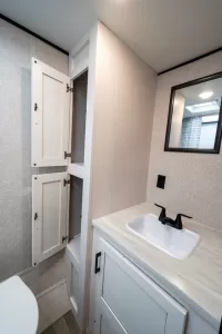 The rear bath includes ample storage for towels and toiletries.