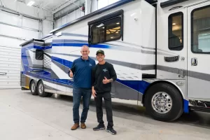 Brian Deegan (right) and Ken Walters (left), Jayco Family of Companies president and CEO, with Deegan’s new Entegra Anthem motorhome.