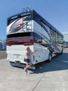 Diane Ehler poses with their new Tiffin Allegro Bus.