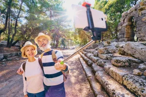 Selfie sticks increase the distance between the camera and subject, reducing distortion.