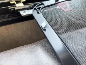 Metal spring clips hold the window screen in place.