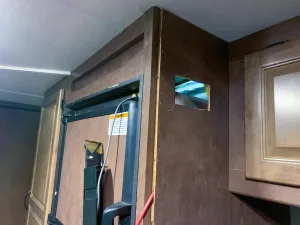 The refrigerator cabinet inside the RV may be a good place to mount the solar controller.