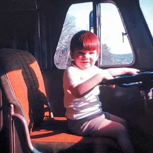 In this 1967 photo, young Doug Beatty is seated at the helm of his grandparents’ Flxible bus, ready to hit the road. 