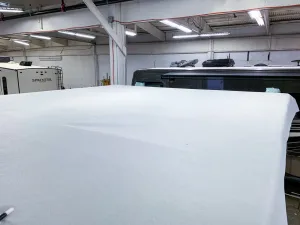 With the wood taken care of, the new rubber can be rolled out onto the roof.