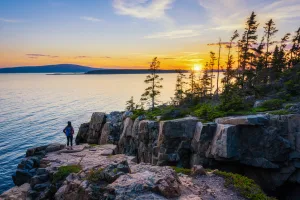 A hiker soaks in the splendor of Acadia’s Schoodic Peninsula.