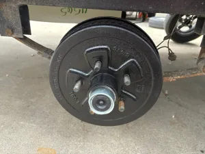 After jacking up the trailer and properly supporting it, take off the wheels.